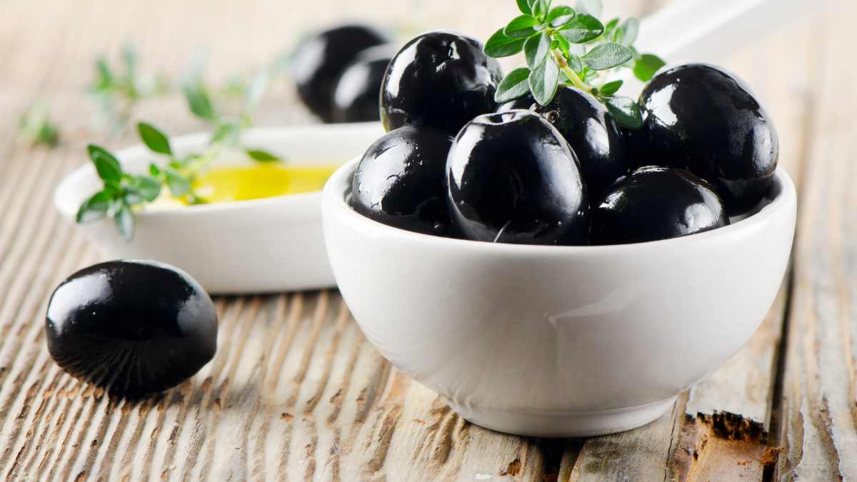 Beautiful black olives in a White bowl