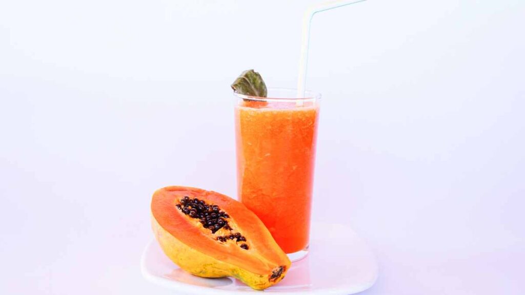 Papaya Juice Glass before a white background